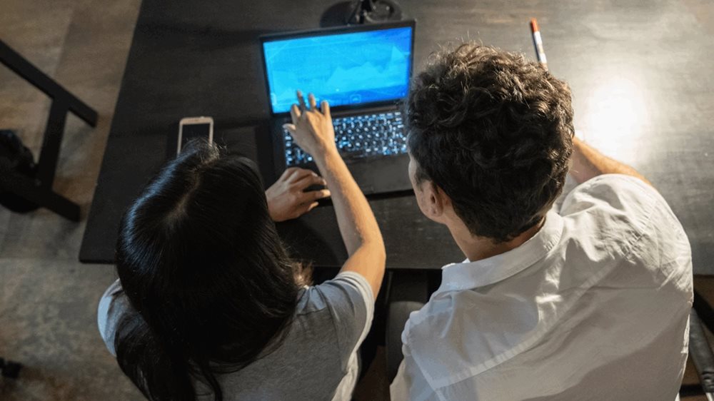 Two People Working on a Computer